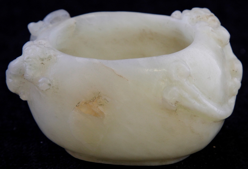 A Qing Dynasty pale green jade brush washer carved with Chih lung dragons, length 8cm (illustrated).