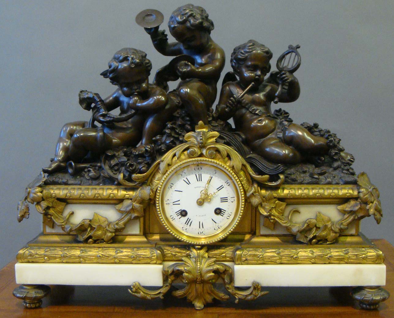 A 19th century French Louis XV style bronze, ormolu, and alabaster figural mantel clock by Marquis a