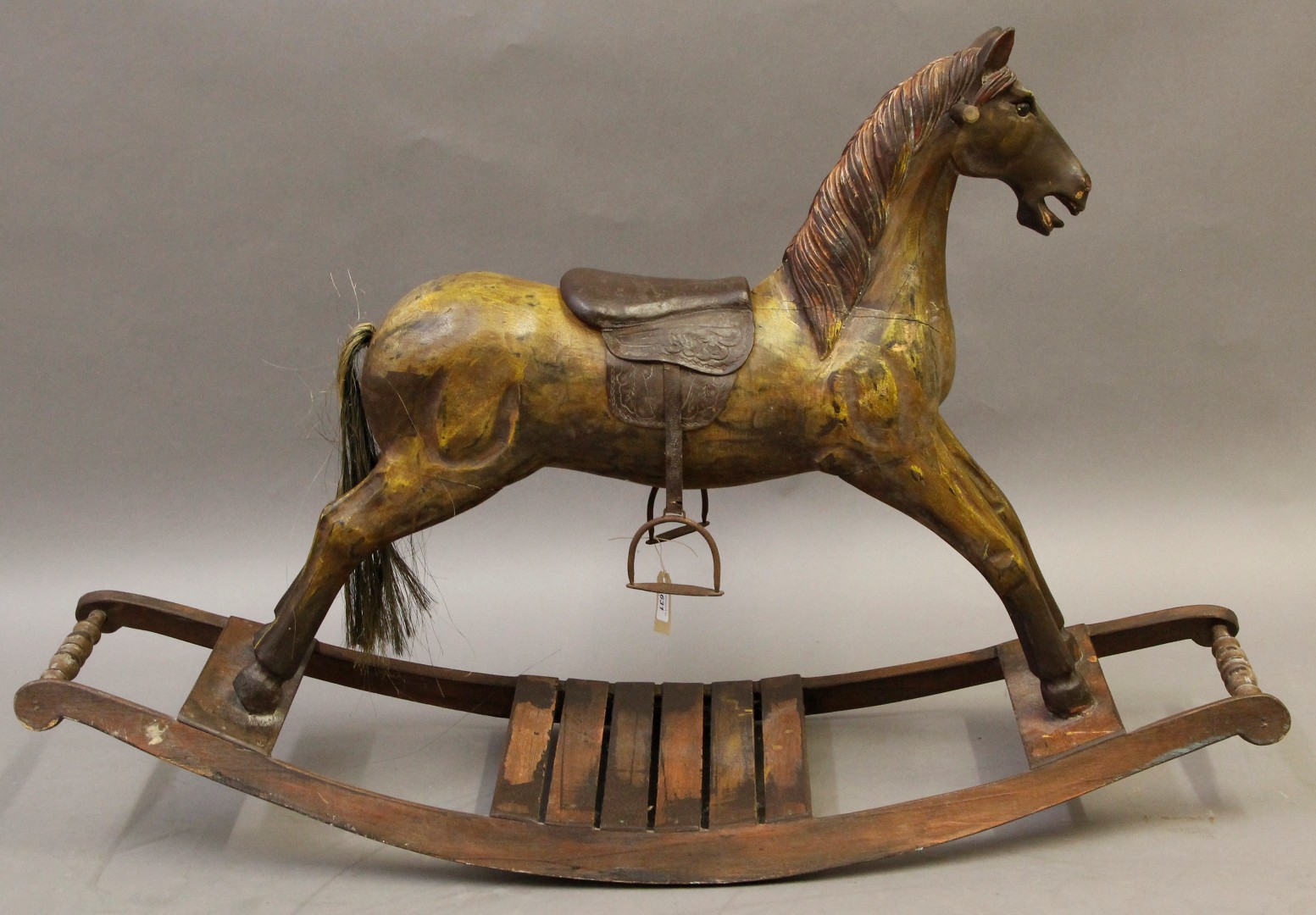 A restored 19th century style wooden rocking horse on a bow rocker with carved wooden main, hair