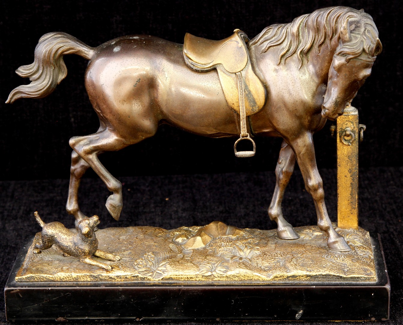 A late 19th/early 20th century bronze and mixed metal figure of a stallion with dog barking by his