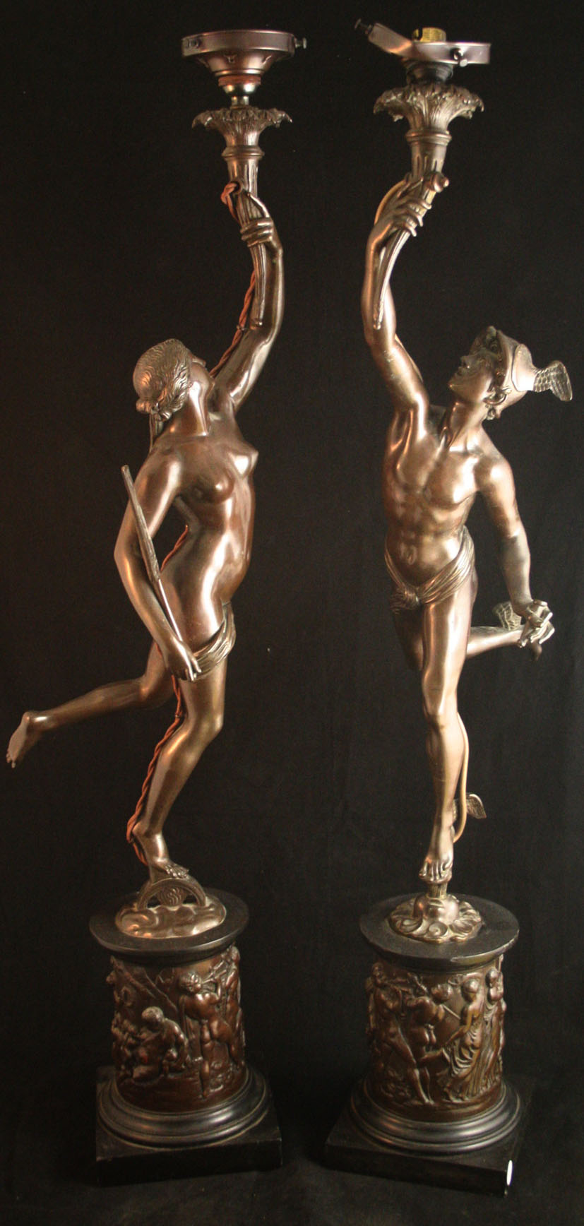 A pair of late 19th century bronze table lamps in the form of Mercury and Venus each holding torches