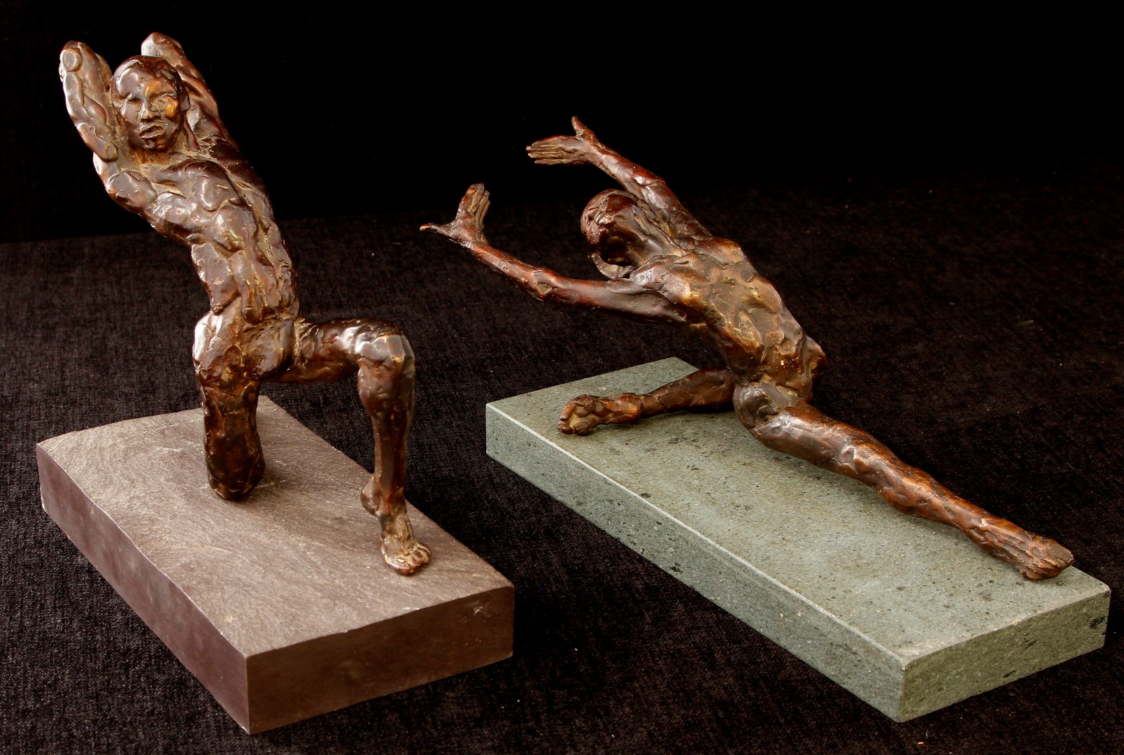 A pair of 20th century unsigned bronze figures of dancers, each modelled in naturalistic ballet