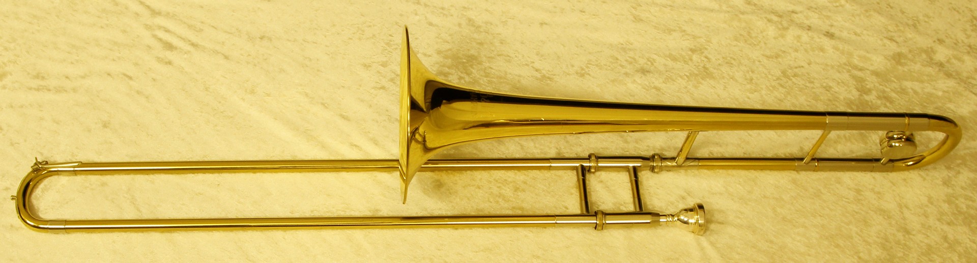 A 20th century B & M Champion brass plated trombone in fitted case, with silver-plated mouth piece