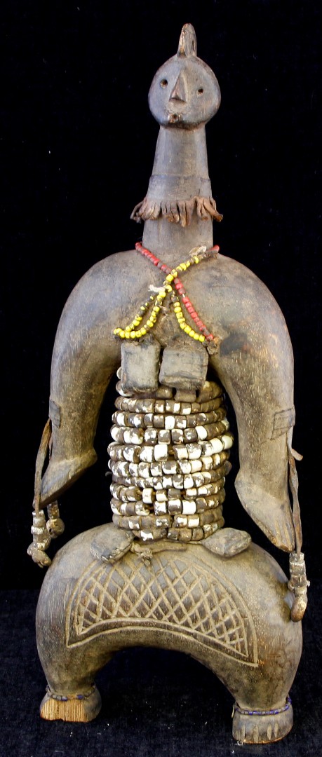 An early to mid 20th century African Tribal Art figure in the form of a male body with eleven beaded