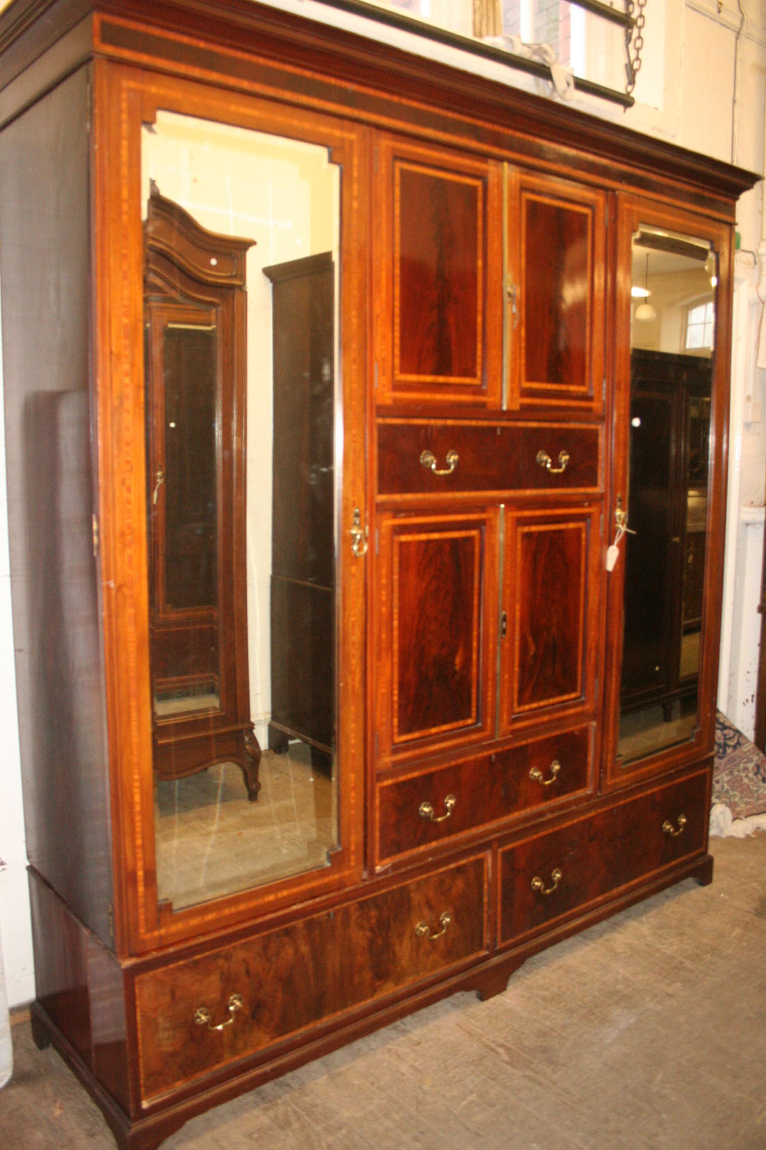 A fine quality Edwardian Sheraton Revival satinwood banded feathered mahogany wardrobe, the