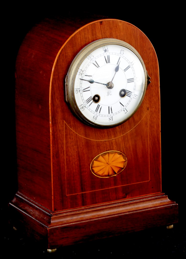 An Edwardian inlaid mahogany cased dome topped mantel clock by Japy Frères, with eight day