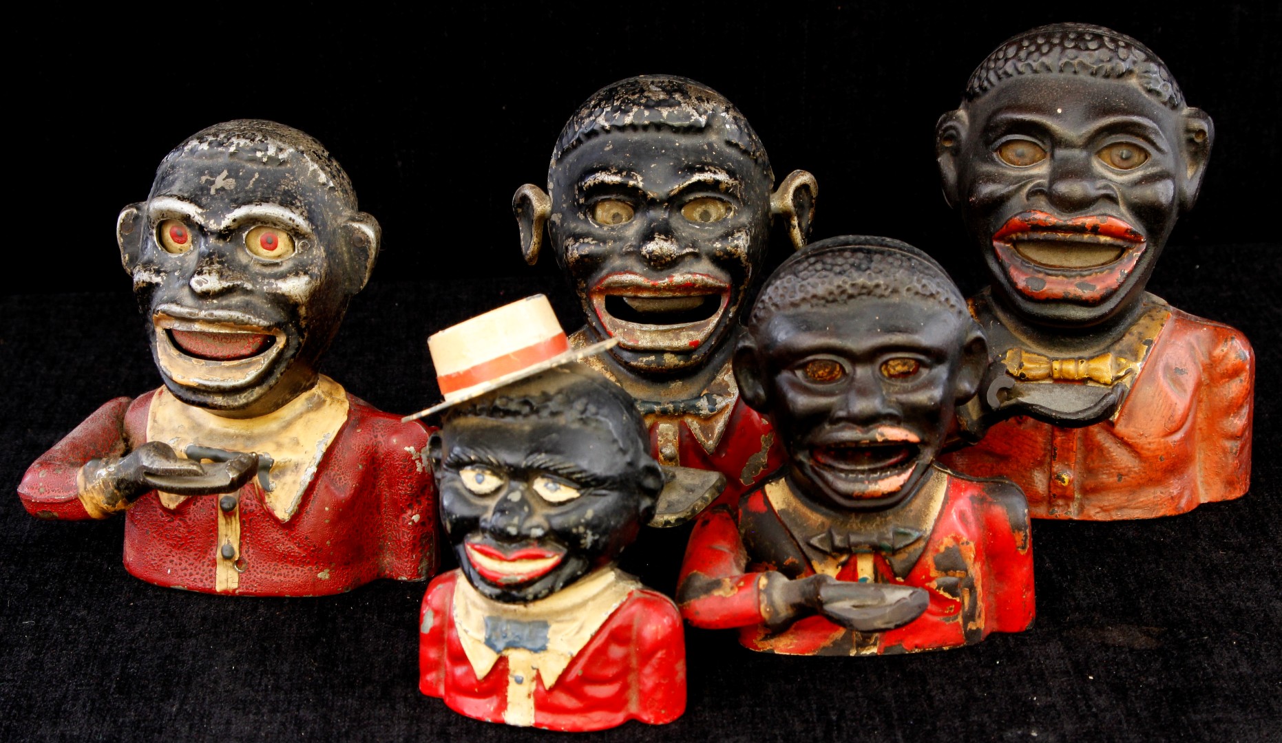 A collection of five 19th century and early 20th century cast iron and cast aluminium Jolly Nigger