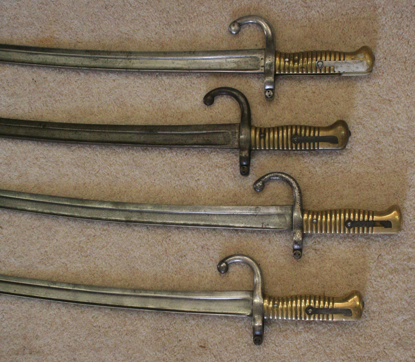 Four French mid to late 19th century Chassepot bayonets with single edged single fullered yataghan