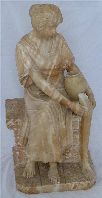 A 19th century carved marble figure of a seated woman with urn form jar, resting on brick built