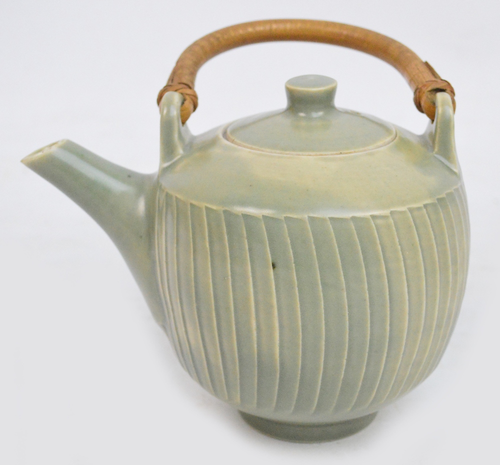 DAVID LEACH (1911-2005) for Lowerdown Pottery; a porcelain fluted teapot with cane handle covered in