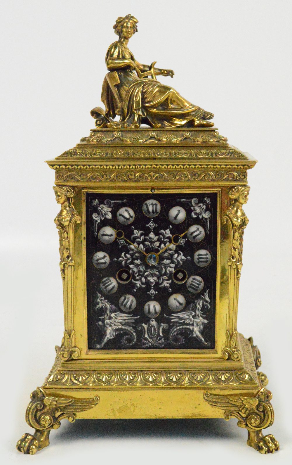 A 19th century French gilt metal mounted mantel clock, the figural surmount above rectangular enamel