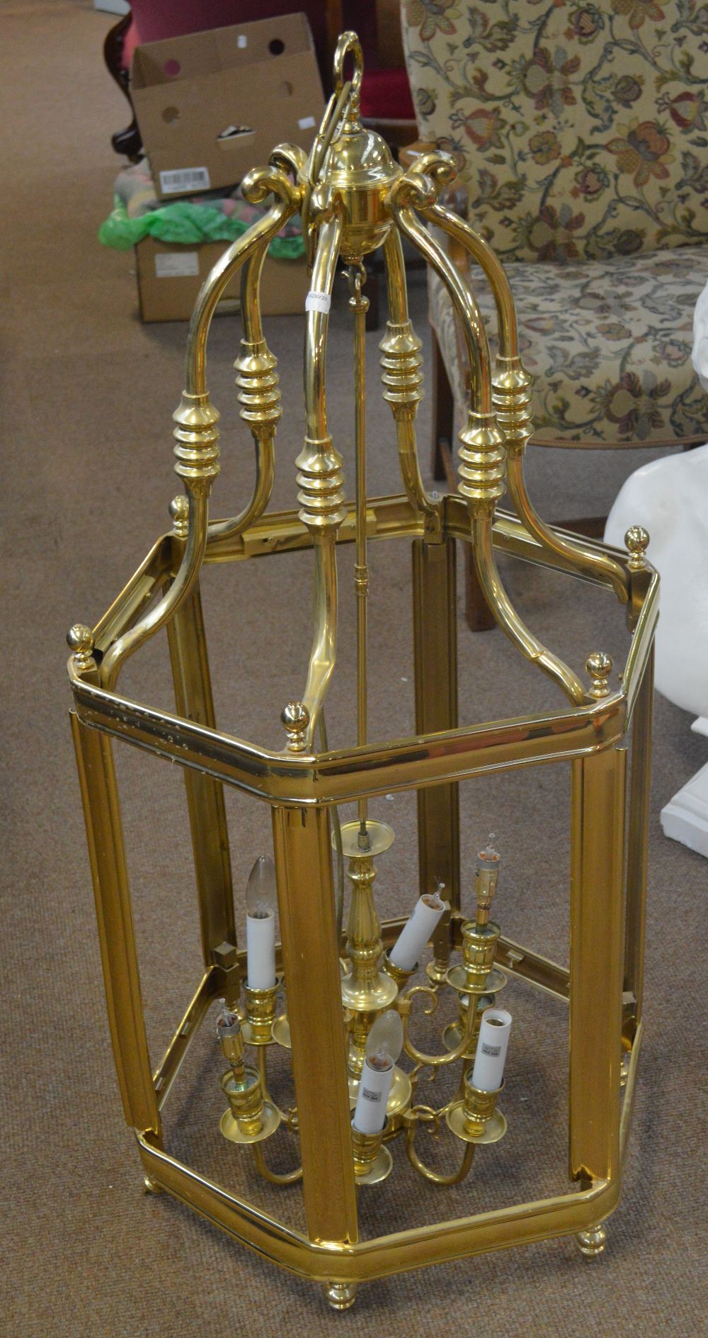 A large brass framed contemporary hall light with central stepped sconces within hexagonal frame (af