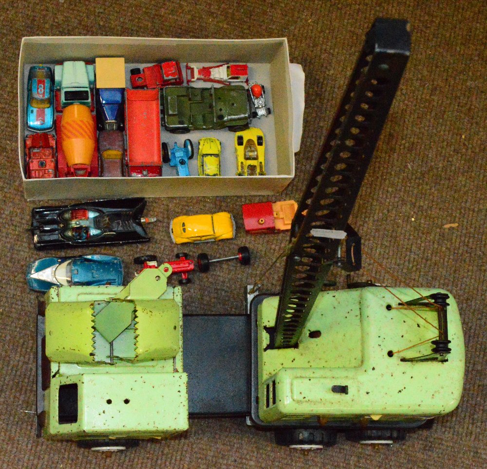 A toy crane and a small quantity of loose scale model vehicles.