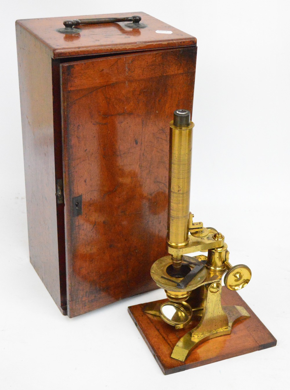 A brass monocular microscope by Baker of London, cased.