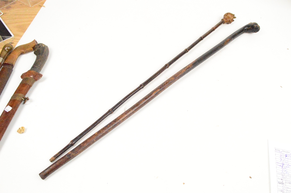 A c.1900 walking cane with horn handle, silver band (hallmarks unclear) and bamboo shaft, length