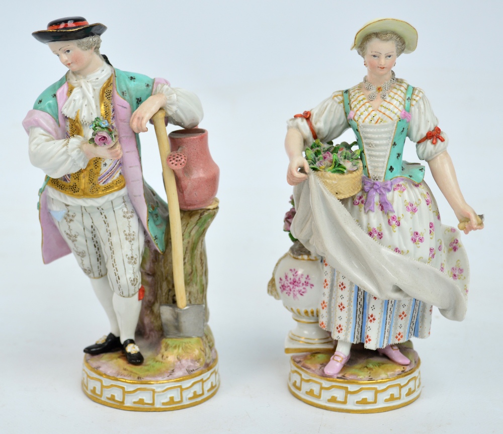 A pair of late 19th century Meissen figures depicting a gent leaning on a spade beside a watering