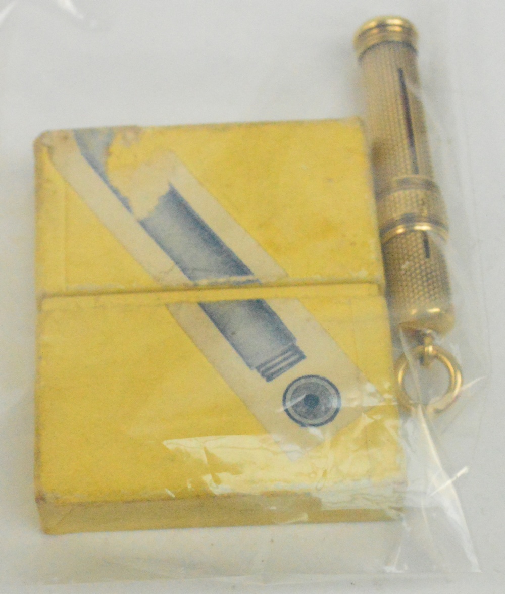 A Sampson Mordan & Co yellow metal propelling pencil of cylindrical form with engine turned