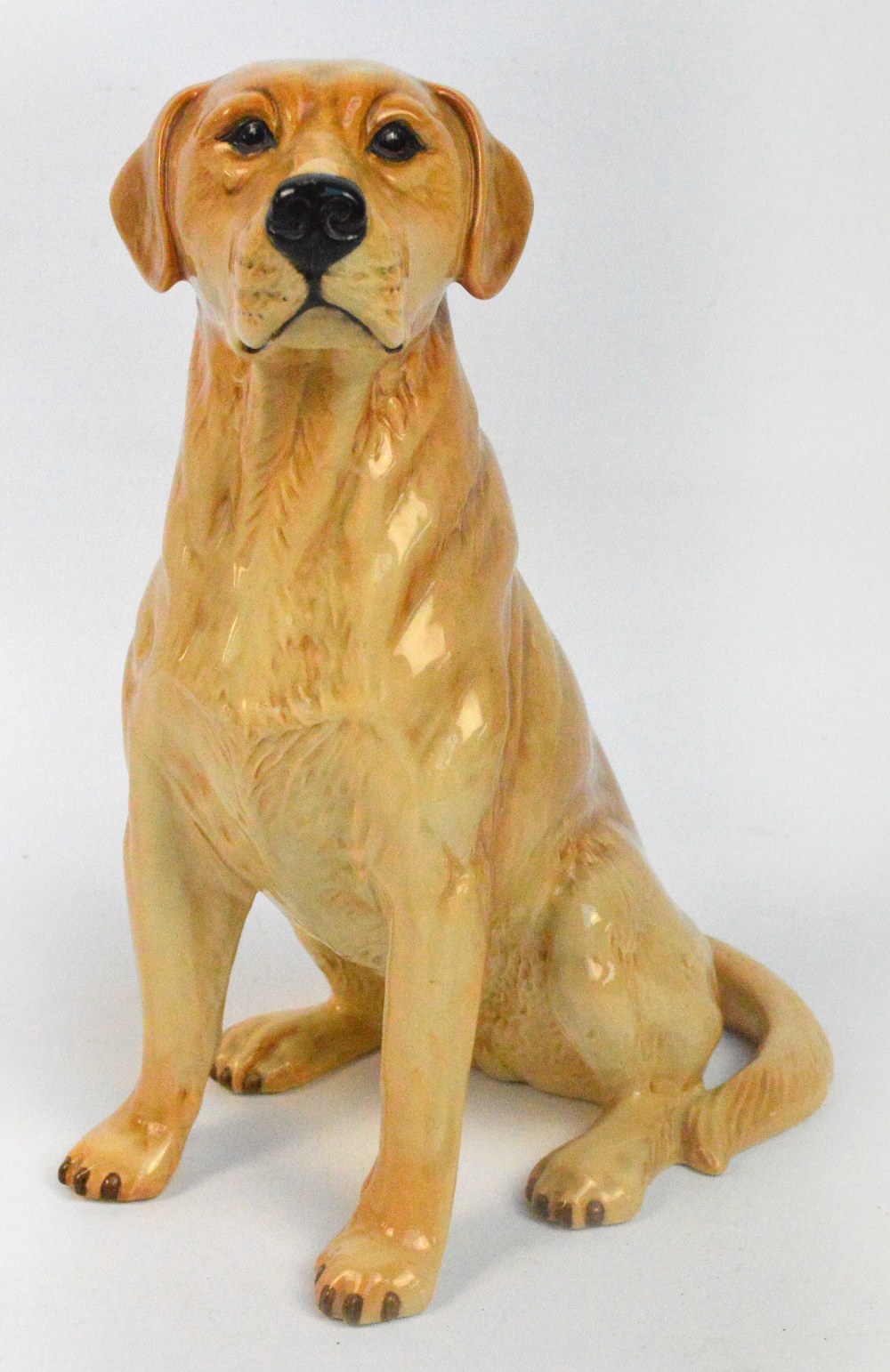A Beswick fireside model of a seated labrador, model 2317, height 34cm.
