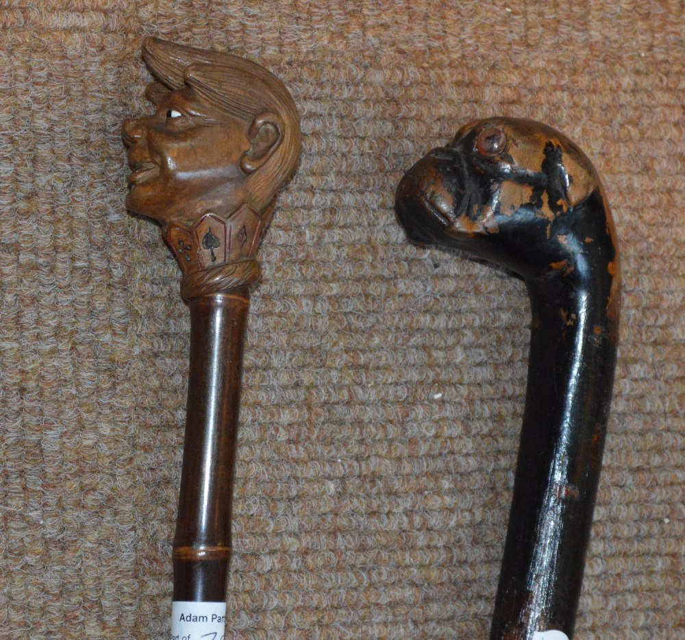 An early 20th century walking cane with carved handle modelled as a young boy's face with pointed