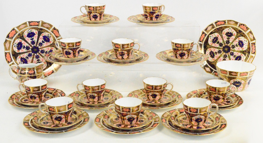 A Royal Crown Derby 1128 pattern Imari decorated tea service comprising two bread and butter plates,