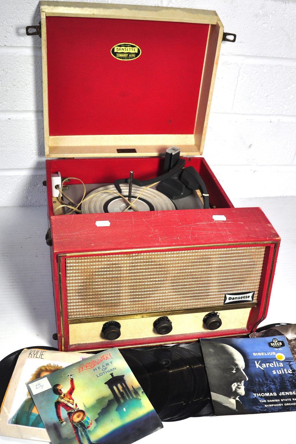 A vintage Dansette record player also with a quantity of singles.