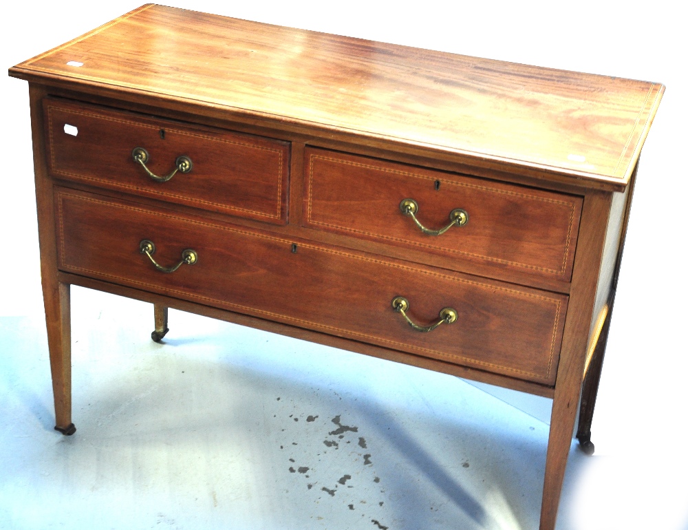 An Edwardian mahogany inlaid chest of two short over one long drawers.