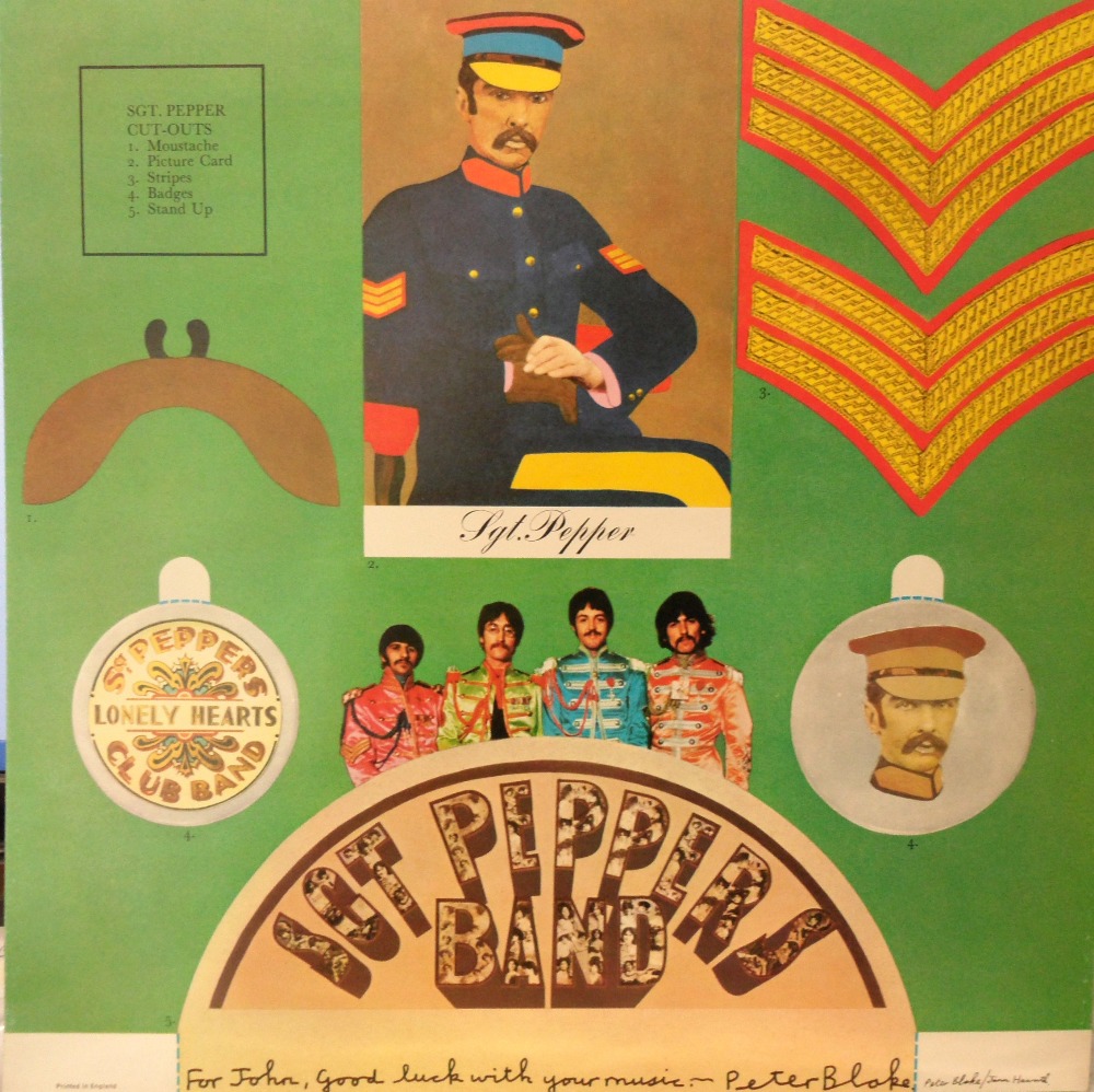 A cut out page from the Beatles Sgt. Pepper album signed "For John, good luck with your music -