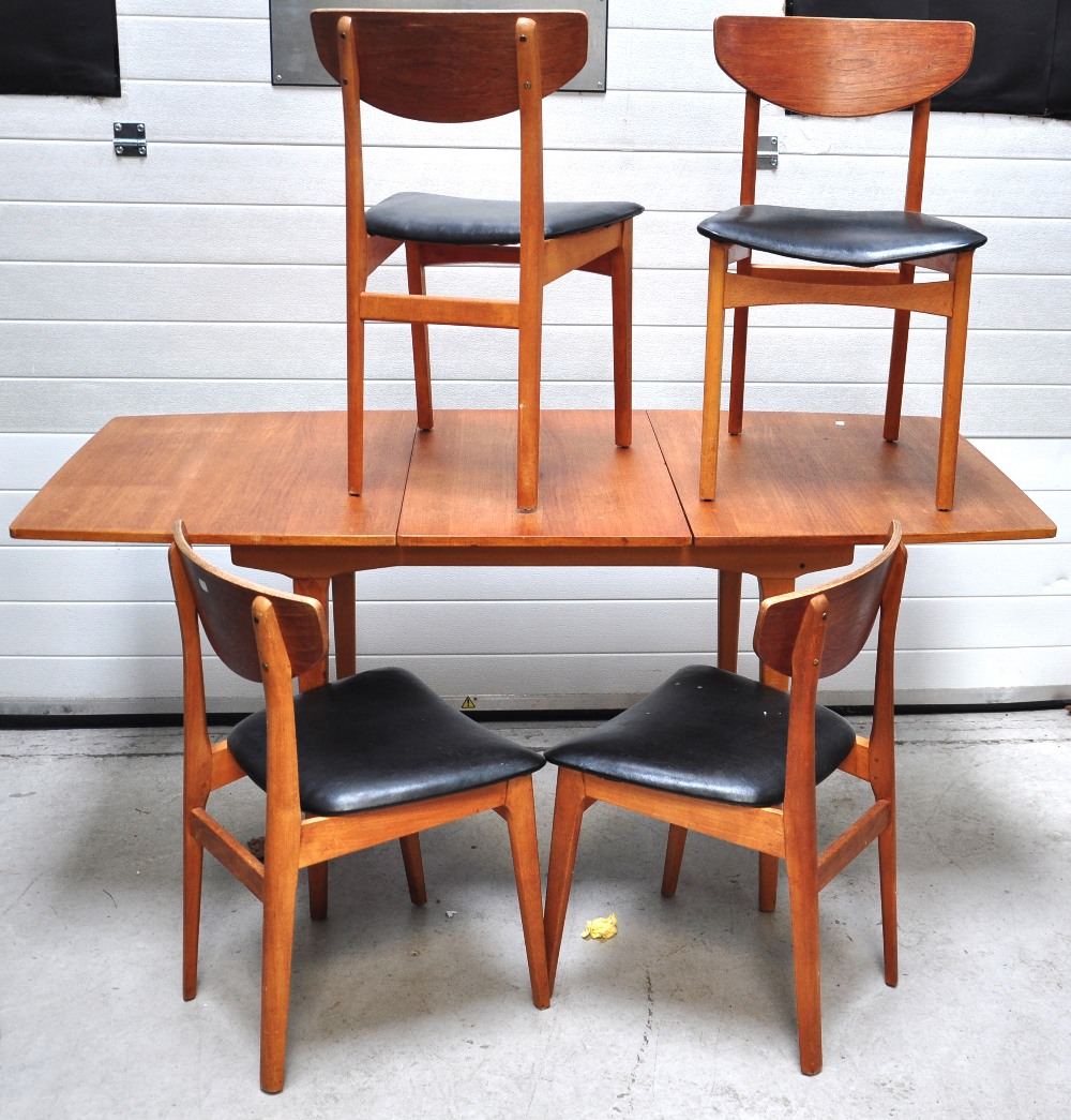 A teak sideboard, table and four chairs.