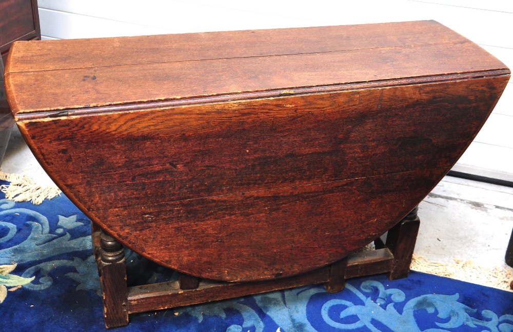 An 18th century oak gateleg dining table, extending width 159cm.