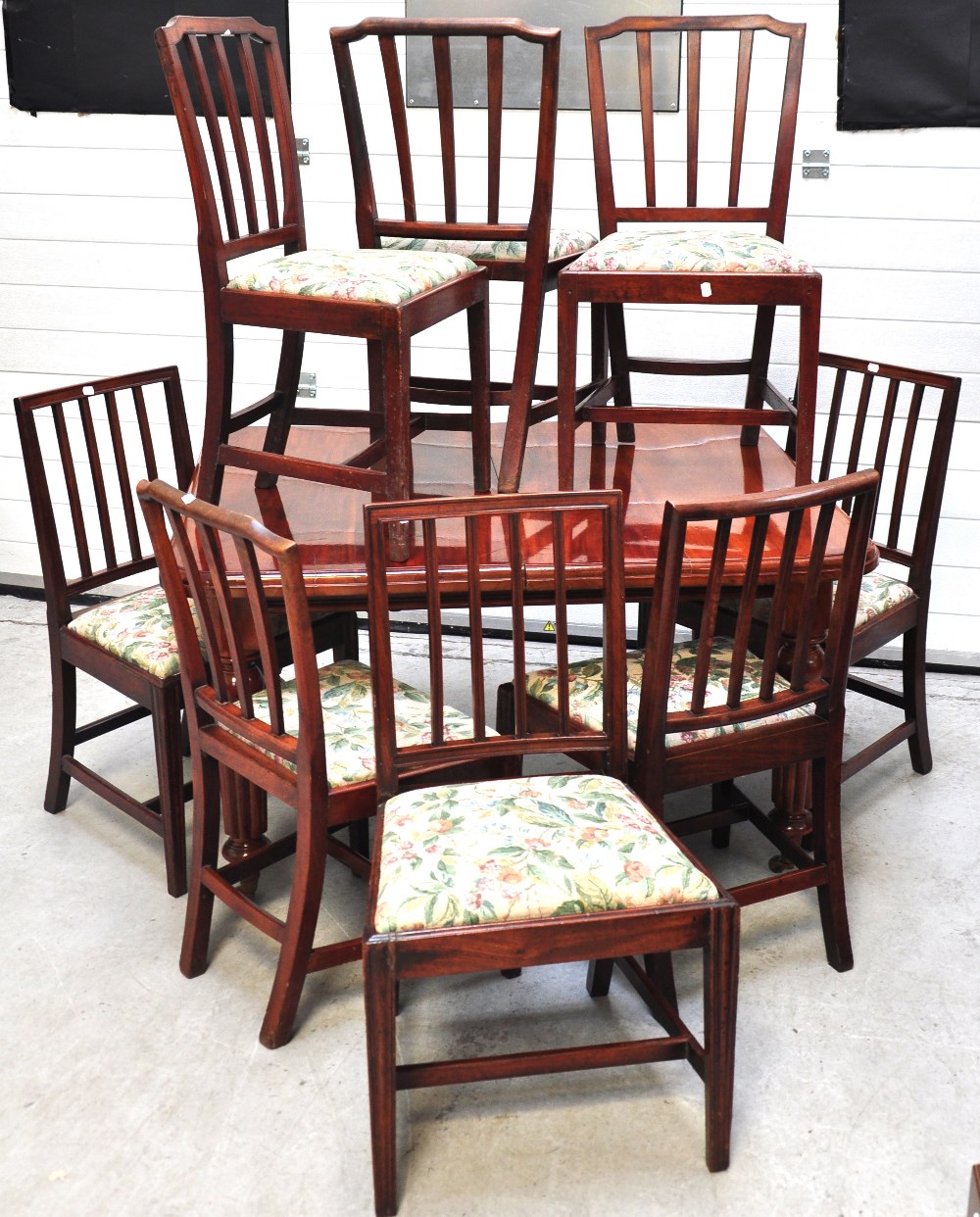 An early 20th century mahogany wind out table on fluted legs and castors, length when extended