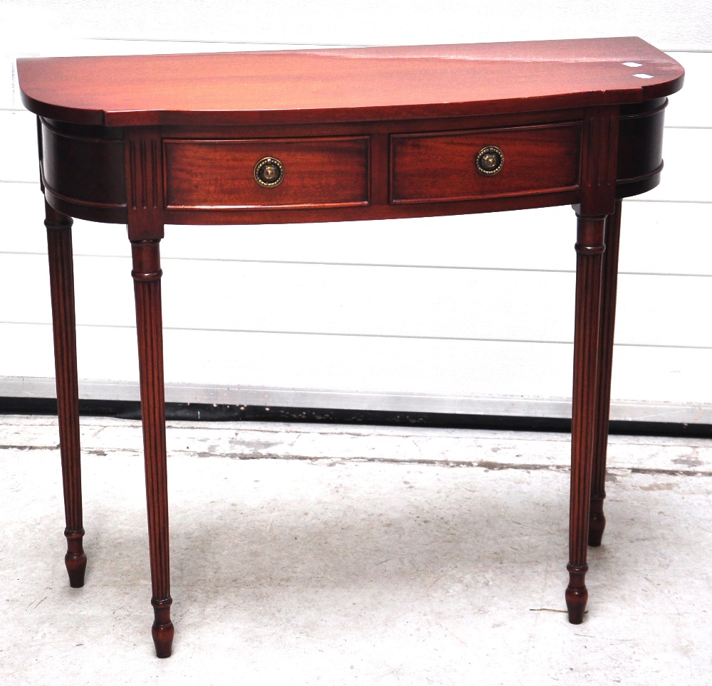 A 19th century fold over mahogany card table and a reproduction hall table on fluted legs.