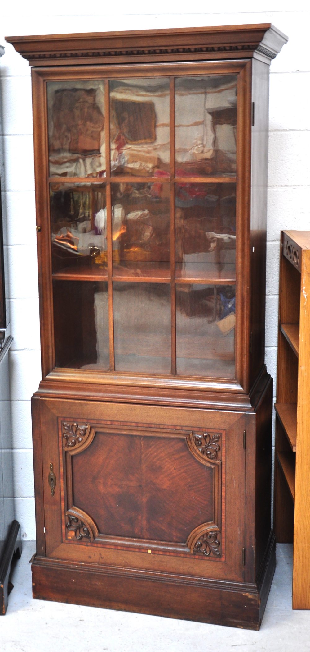 A reproduction glazed bookcase on cupboard base, height 189cm.