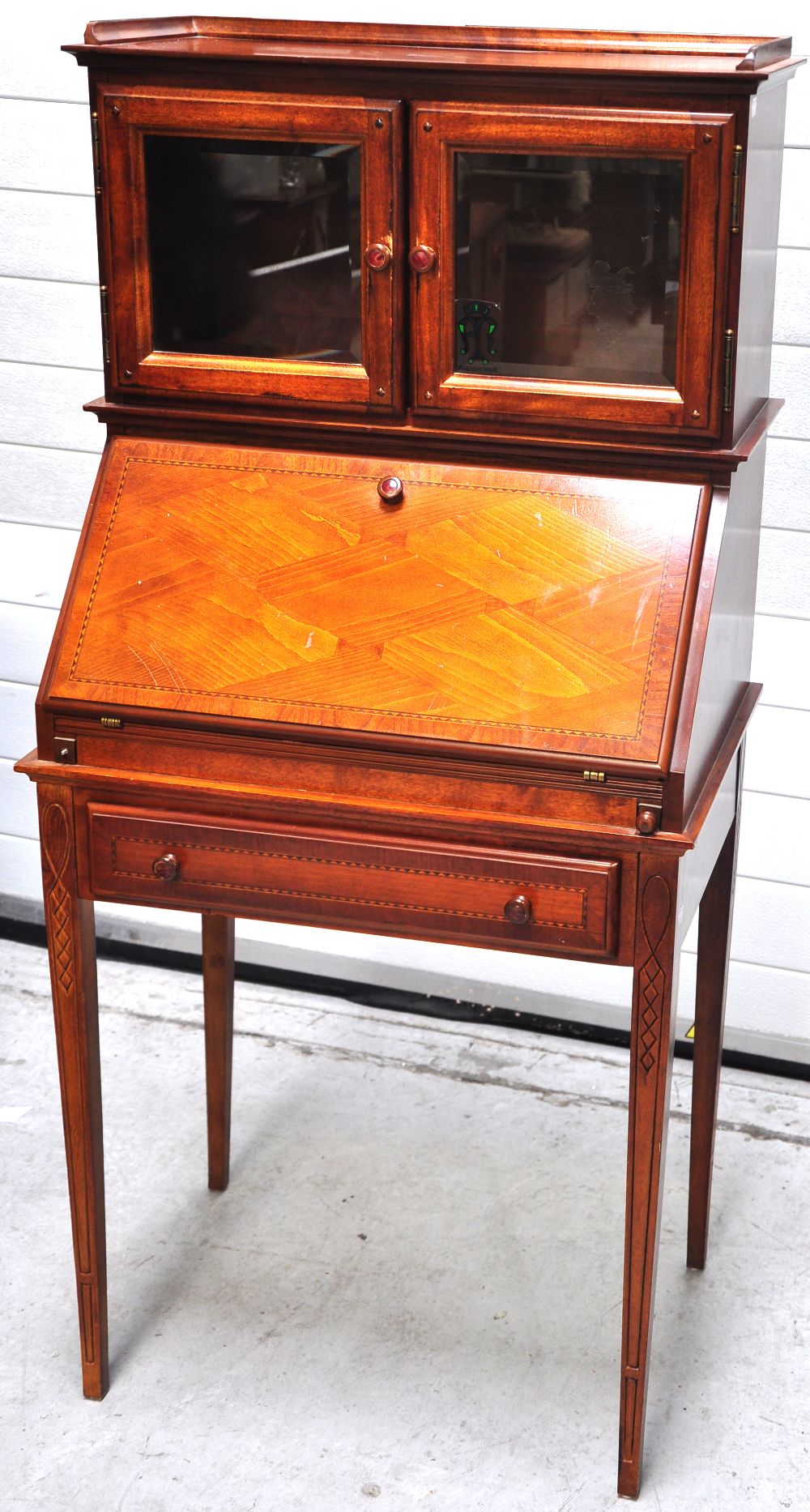 A reproduction bureau display cabinet on tapering square section legs, height 141cm.