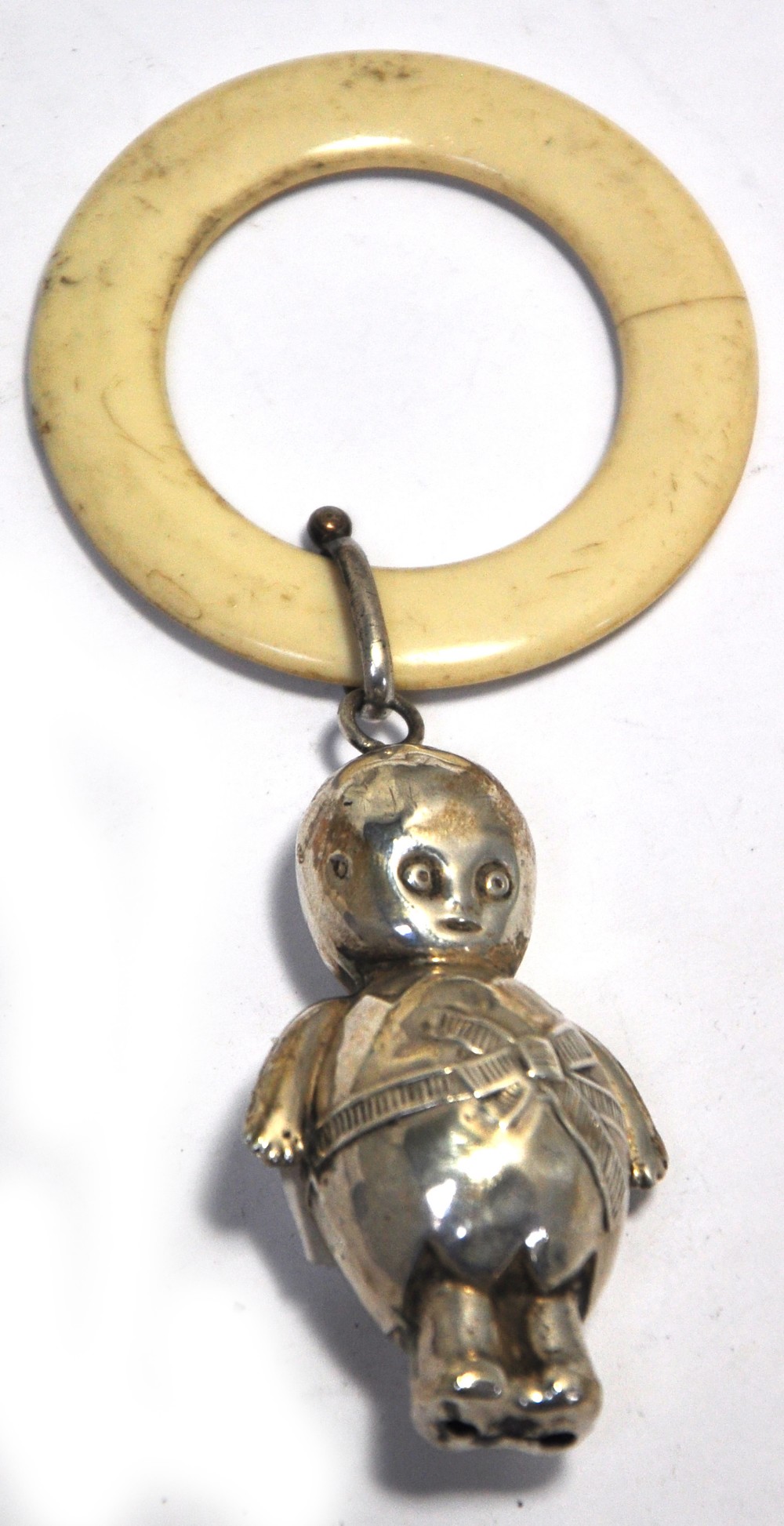 A hallmarked silver and ivory baby's teething ring with a Kewpie doll decoration, Chester date