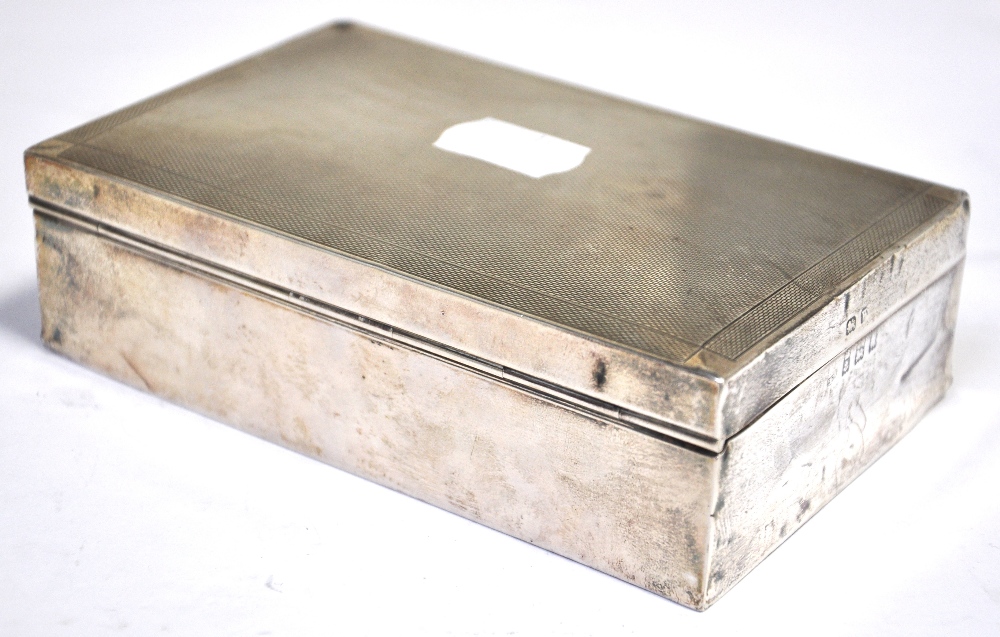A George V hallmarked silver cigarette box, Birmingham 1940, length 14cm.