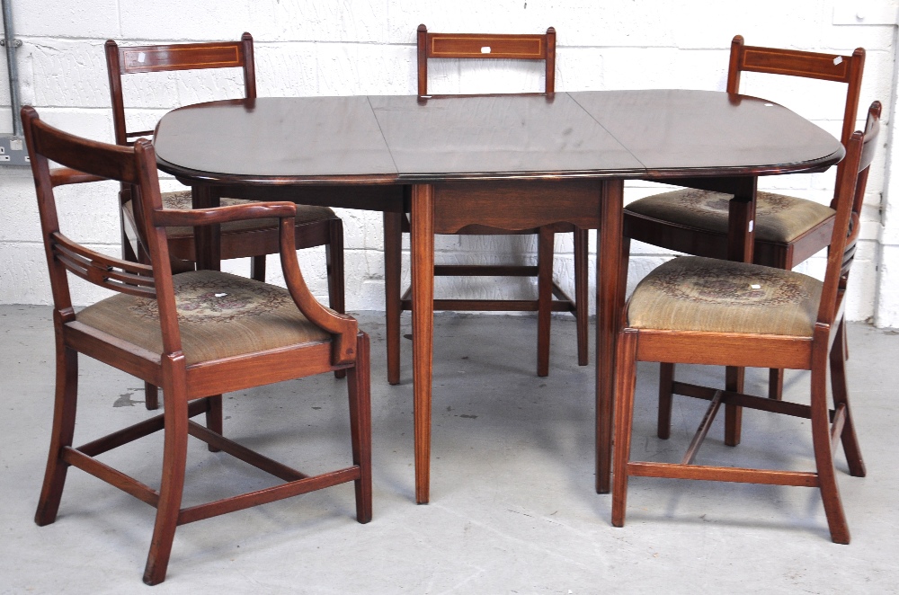 An Edwardian dropleaf dining table with six inlaid chairs, table extended 154cm. (7).