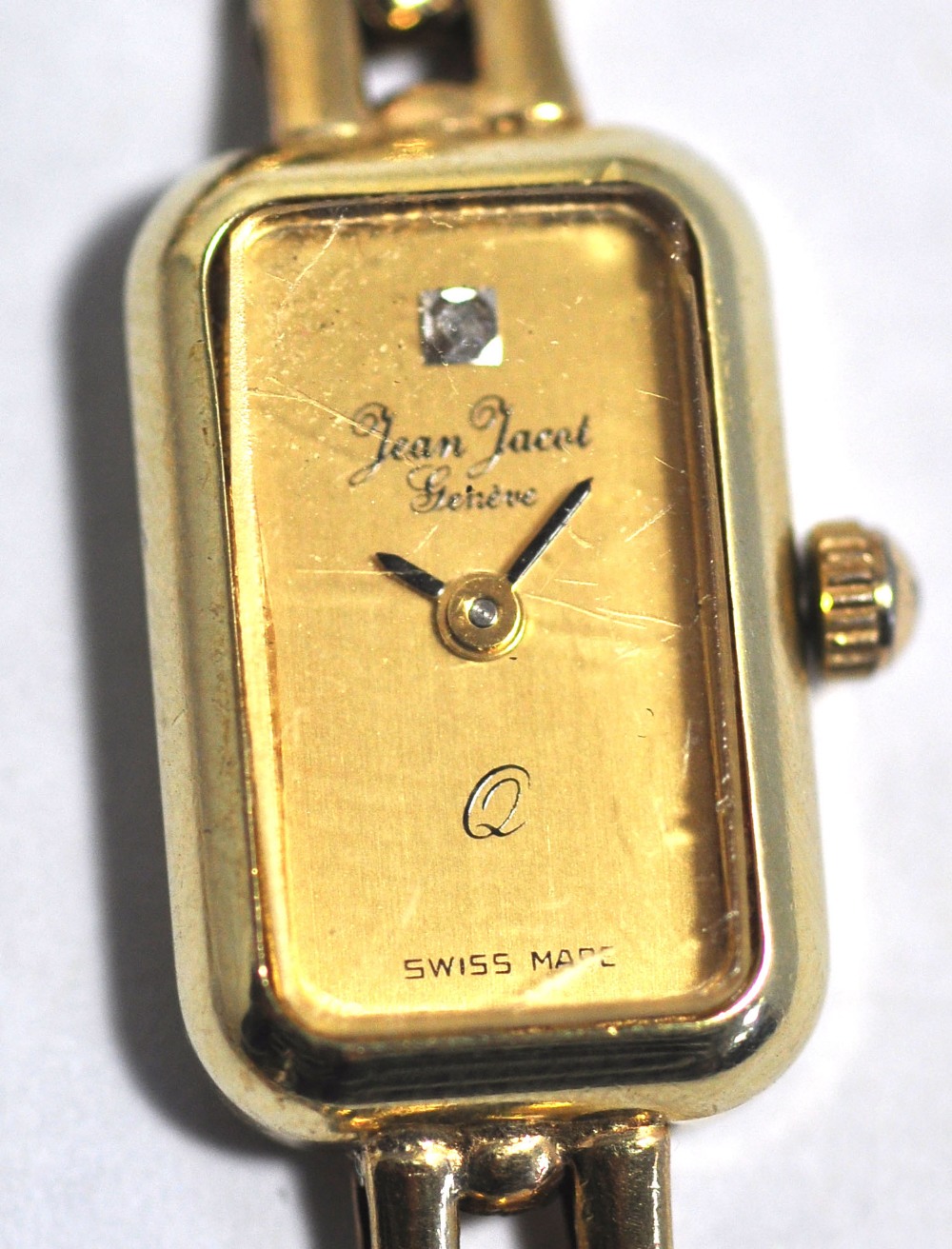 A vintage ladies Jean Jacot Swiss 9ct gold wristwatch, the rounded rectangular dial set with a