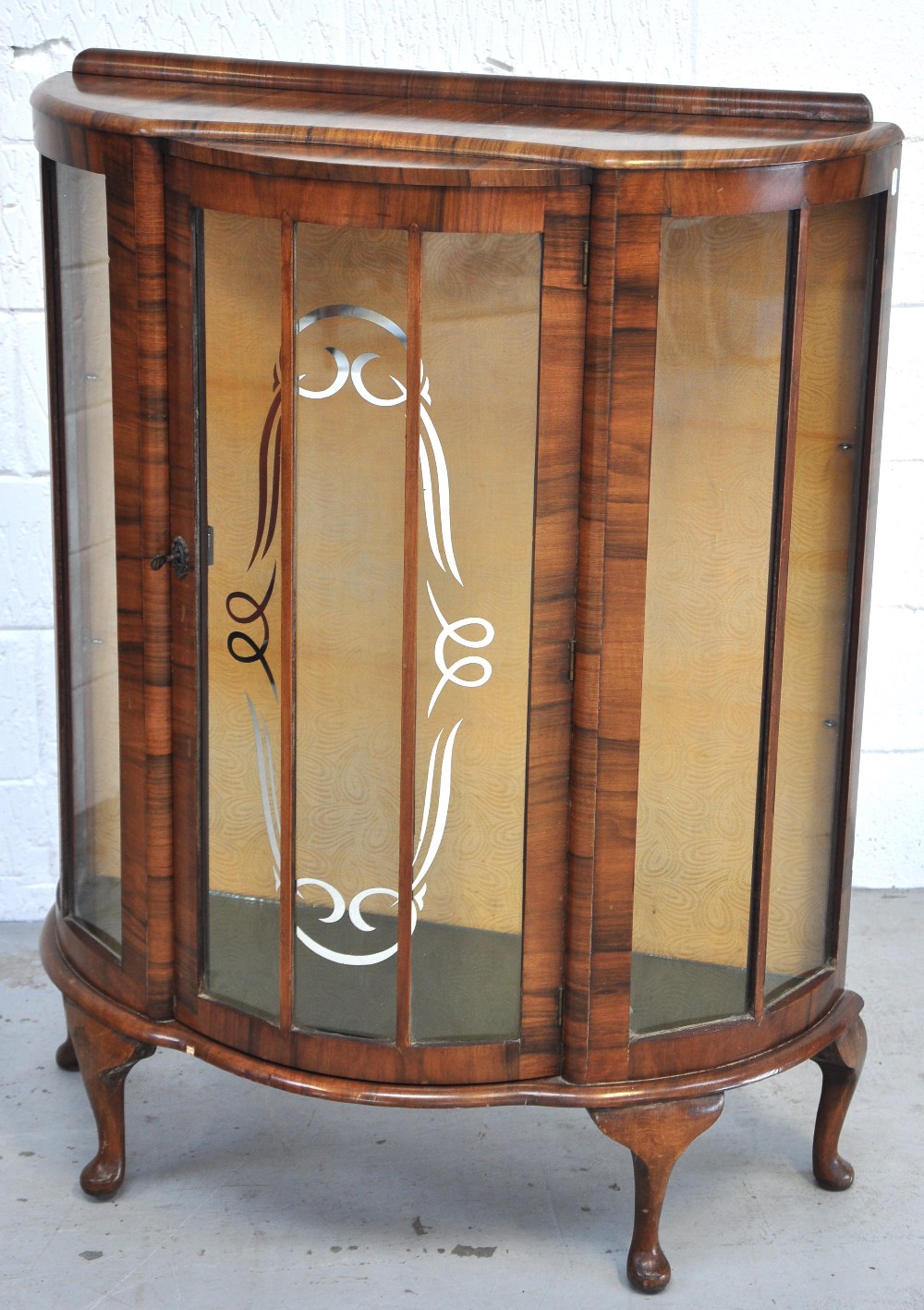 A walnut veneered 20th century display cabinet raised on cabriole legs with silver decoration to the