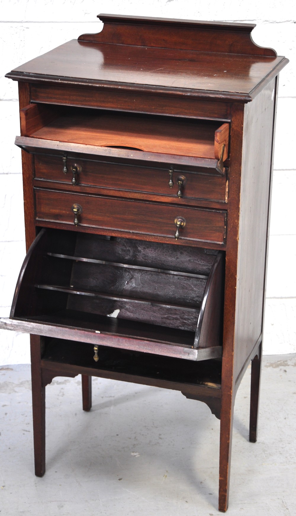 An Edwardian music cabinet, three drawers over a pull out music holder.