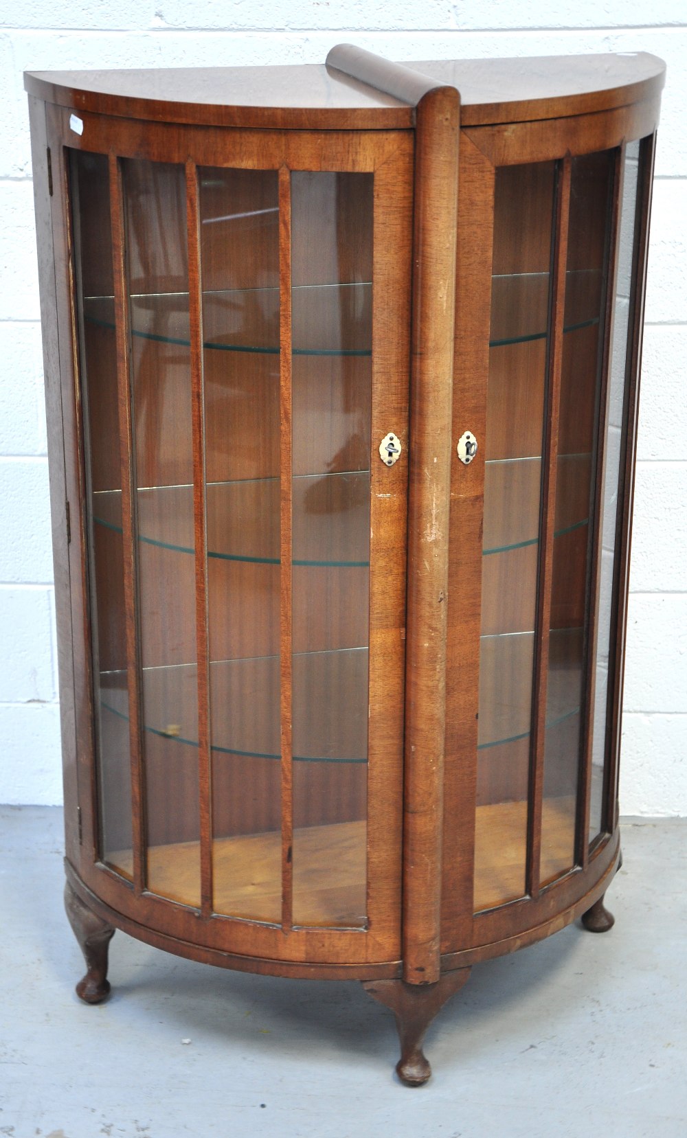 A 20th century bow fronted display cabinet on cabriole legs, width 77cm.