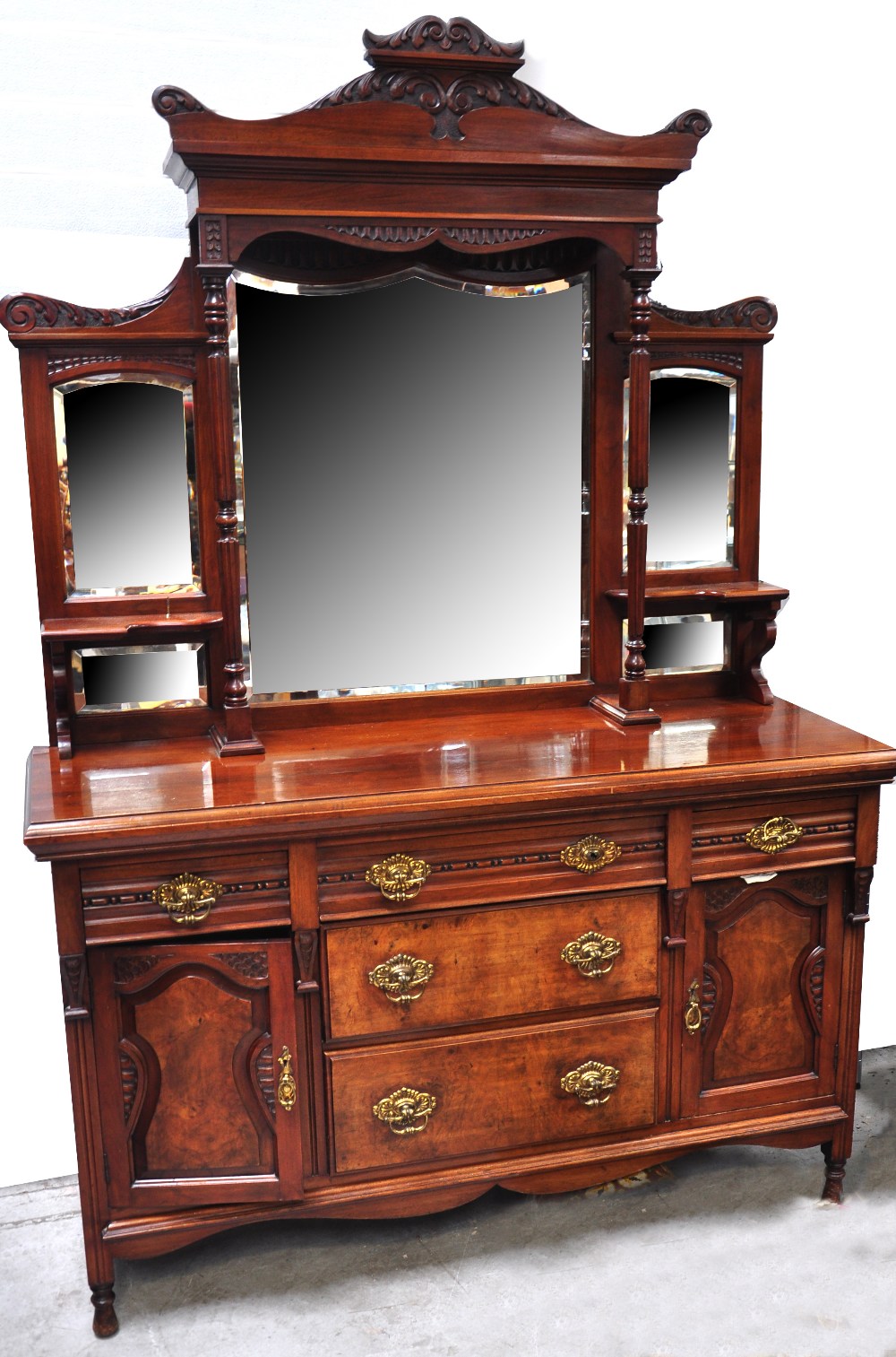 A late 19th century walnut mirror back sideboard, the three central doors flanked by twin