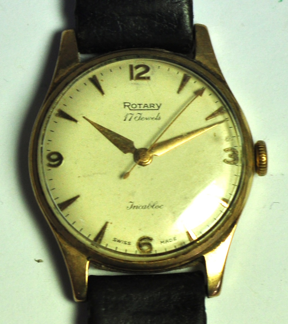 A gents yellow metal Rotary watch with brown leather strap.