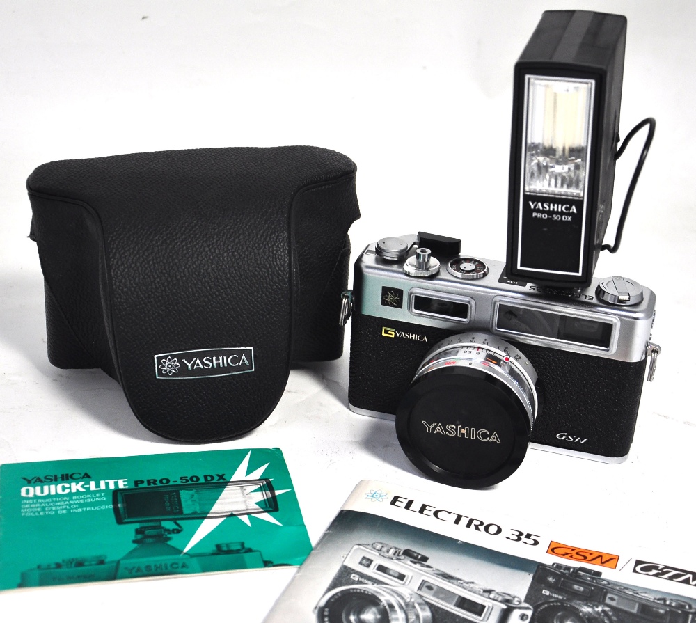 A Yahsica Electro 35 camera with case instructions and Yashica Pro-50DX electronic flash gun.