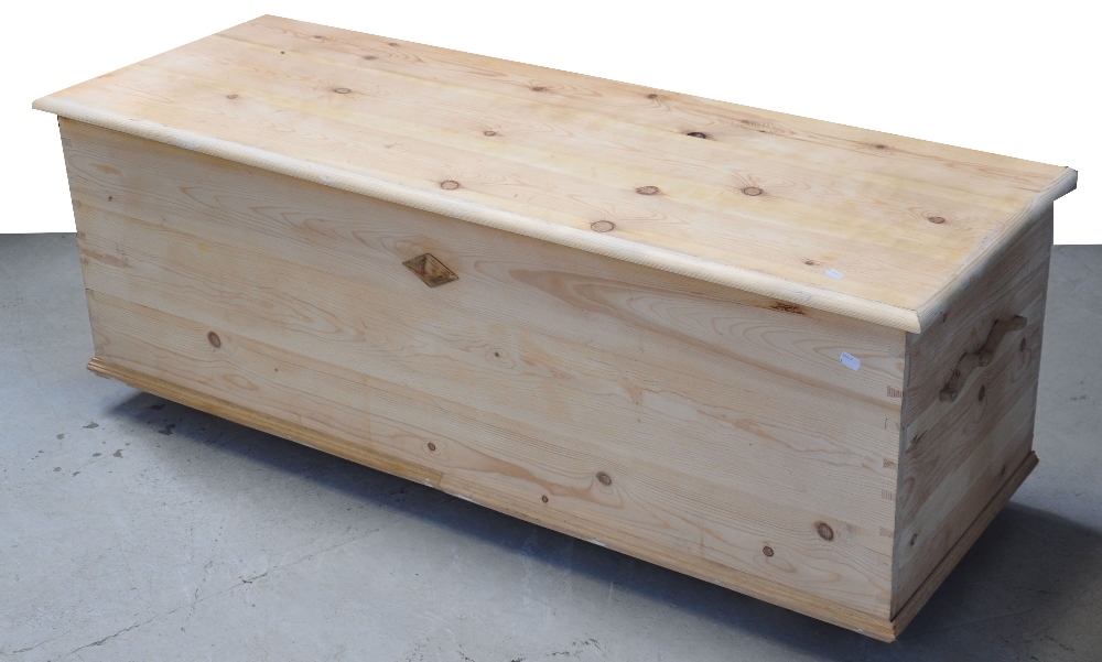 A contemporary pine blanket box with hinged lid and diamond motif to the front, length 140cm.