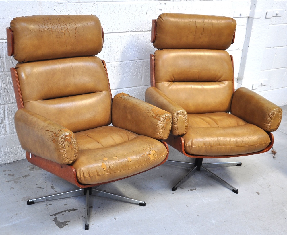 Two Eames style lounge chairs.     CONDITION REPORT  The leather covering has perished badly on