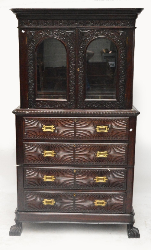 An Indian rosewood secretaire bookcase on chest, the upper section with two glazed doors enclosing a