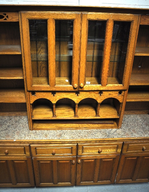 A contemporary kitchen wall unit with drawers and cupboards to the base, a central glazed display