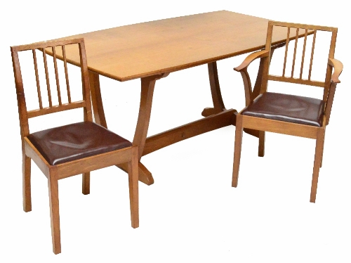 An Alan Grainger Acorn Industries oak dining table and six matching chairs, each carved with