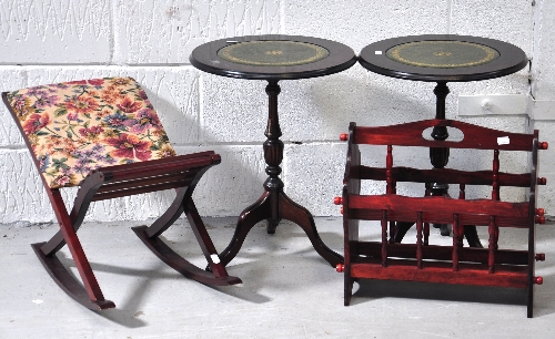 Two small circular reproduction leather topped occasional tables, a magazine rack and a child's