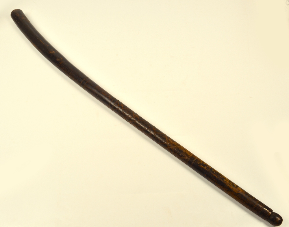 An early 20th century African ebonised cudgel with incised geometric decoration towards the grip,